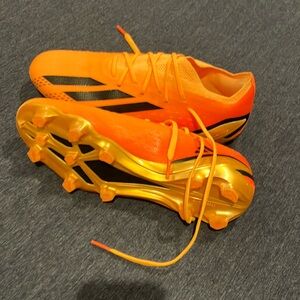 Orange, gold, and black adidas crazy fast elite soccer shoes